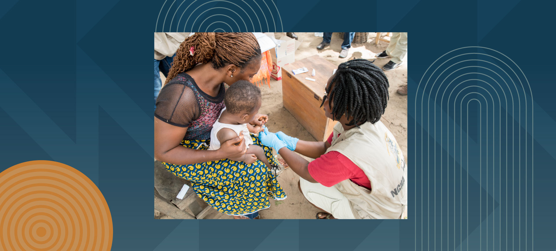 Healthcare worker in white uniform administering a vaccination to a young child being held by a woman in colorful traditional dress, taking place outdoors in what appears to be a community health clinic setting