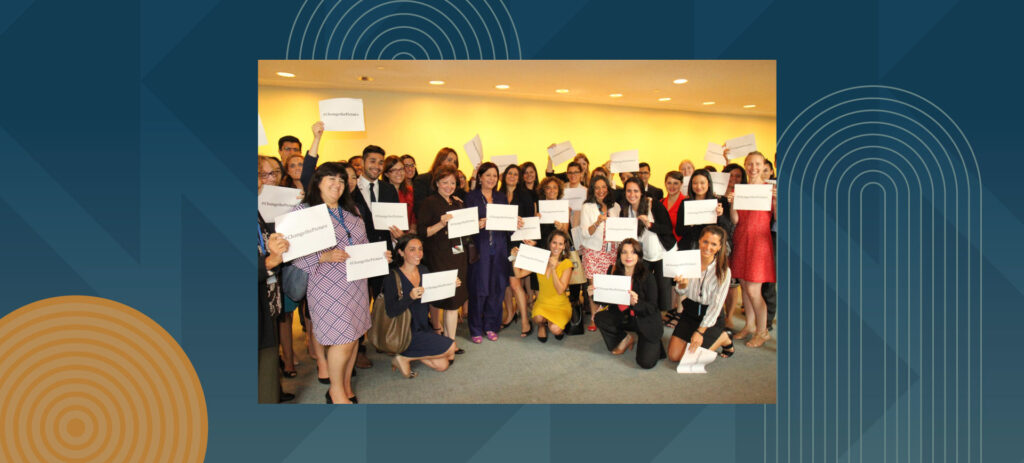 Large group of professional women holding certificates at graduation or achievement ceremony in office setting